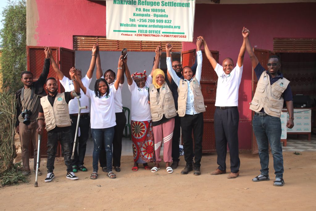 A group of people join their joins in unity in Uganda. 