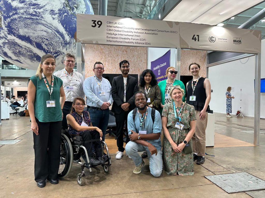 A group of people gather for a photo inside a convention center
