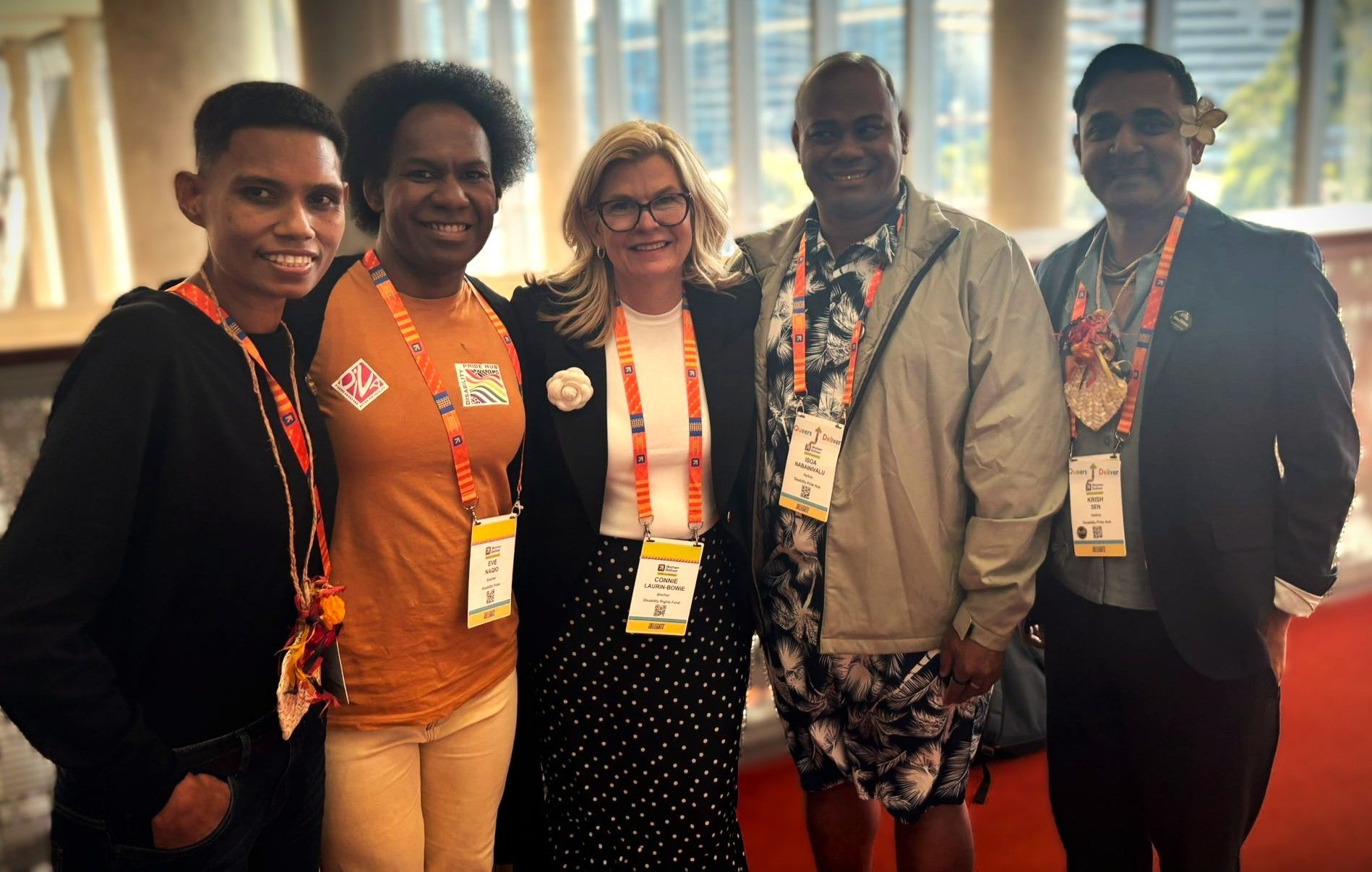 The Disability Pride Hub team and DRF's ED Connie smile at the Women Deliver conference