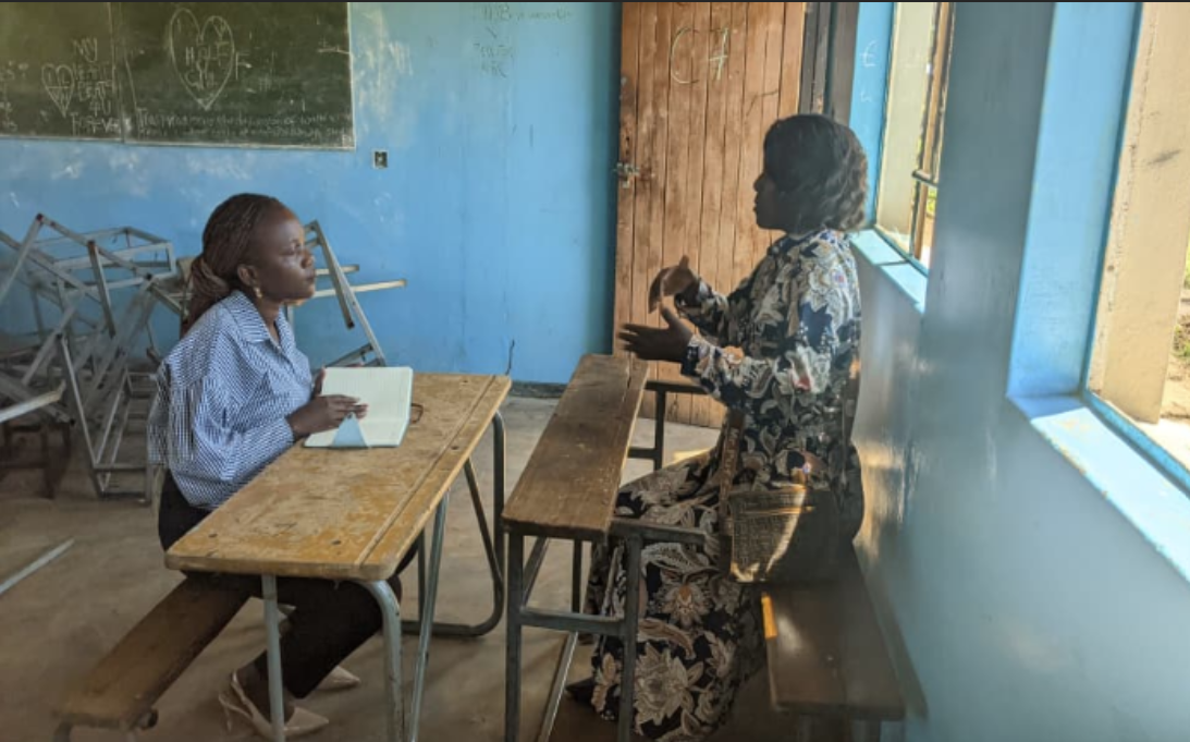 Two women sitting together in a meeting